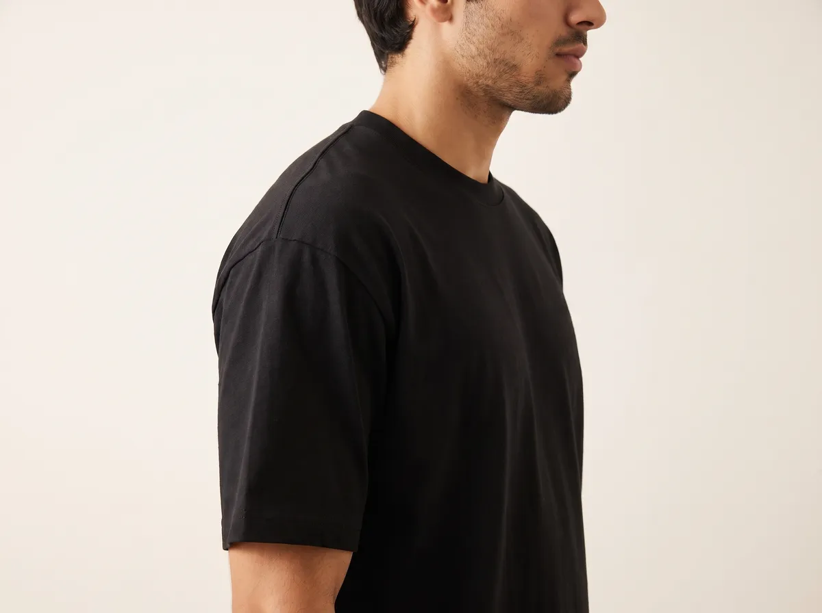 The oversized t-shirt worn, showing the forward shoulder